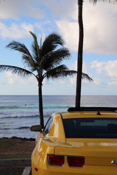 Yellow rental car parked on Oahu beach